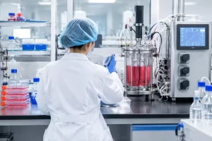 Researchers are conducting experiments using cell culture and bioprocessing equipment.